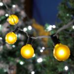 25 G40 Globe String Light Set with Yellow Satin Bulbs on Black Wire