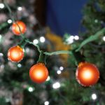 100 G40 Globe String Light Set with Orange Bulbs on Green Wire