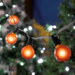 100 G40 Globe String Light Set with Orange Bulbs on Black Wire
