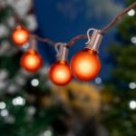 100 G40 Globe String Light Set with Orange Bulbs on Brown Wire