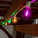 25 LED Filament G40 Globe String Light Set with Transparent Yellow, Purple & Green Bulbs on White Wire